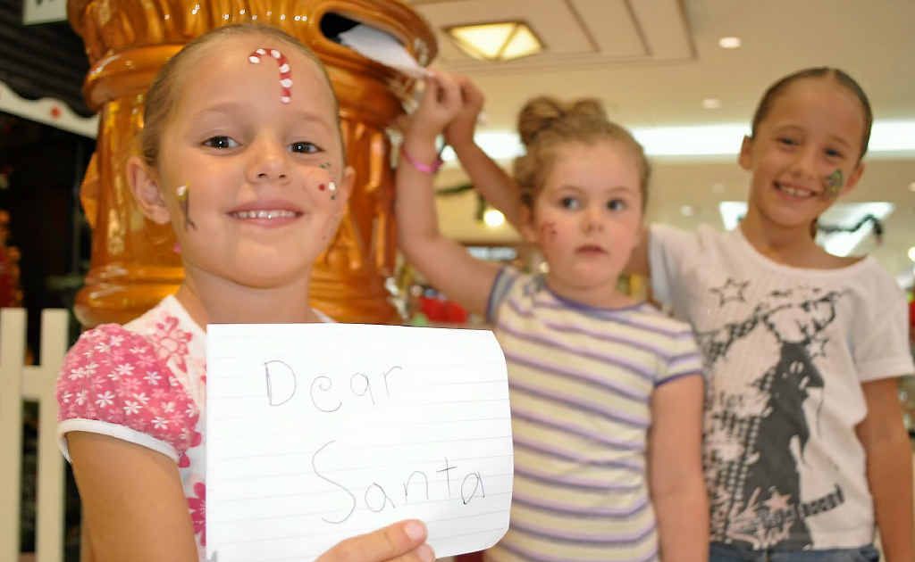 Stephanie Lyons, (back) Melissa Lamb and Christie Lyons post their letters to Santa. Stephanie Lyons, (back) Melissa Lamb and Christie Lyons post their letters to Santa.